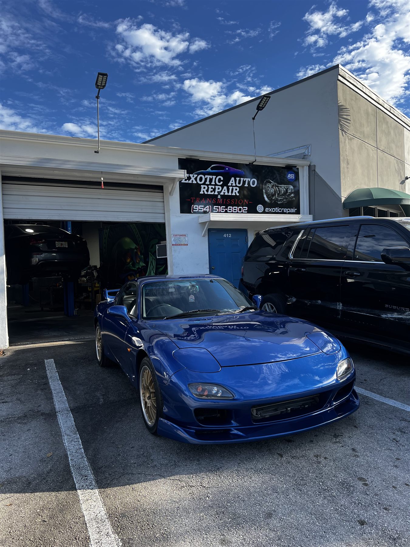 Blue sports car parked outside Exotic Auto Repair And Transmission
