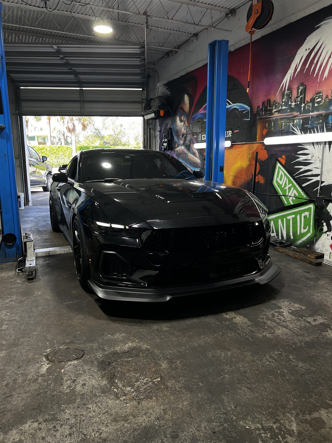 Black exotic car being serviced inside the shop